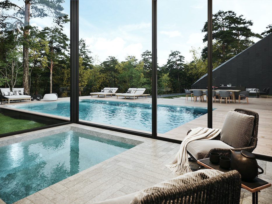 A house with a swimming pool in the middle of a wooded area.
