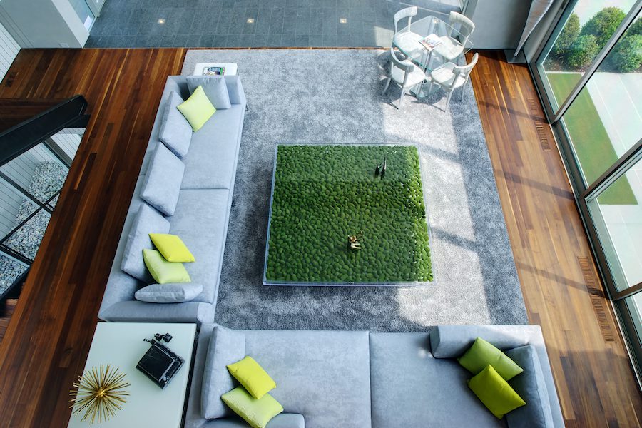 An aerial view of a living room with green grass on the floor.