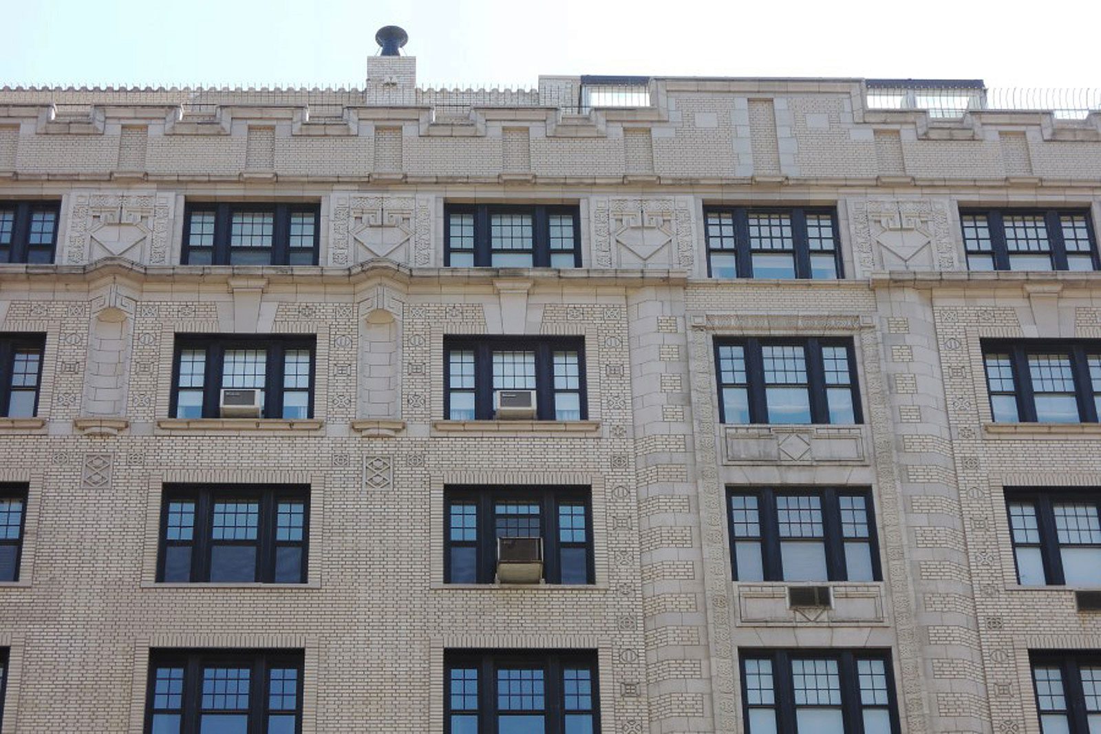 A large building with many windows and a clock.