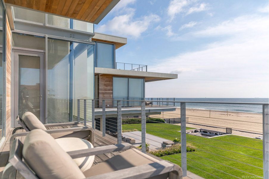 A balcony overlooking the beach and ocean.