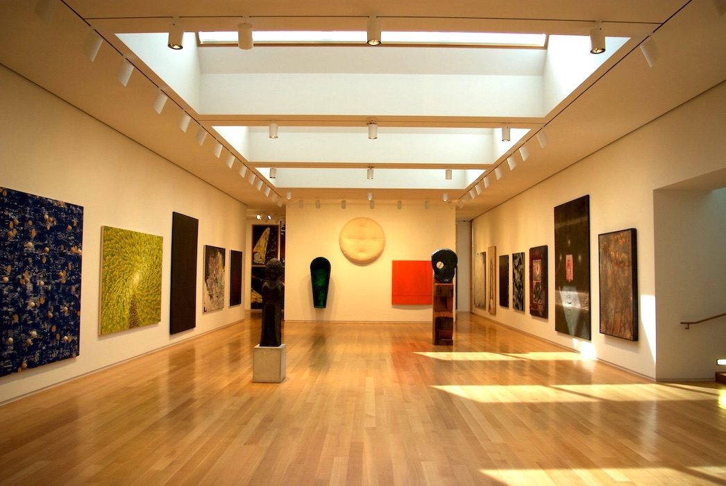 An art museum with many paintings on display.