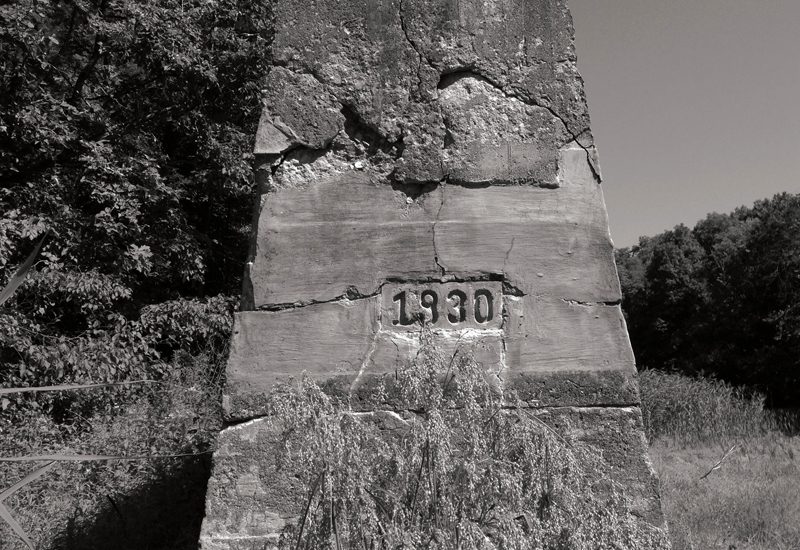 A black and white photo of a stone monument.