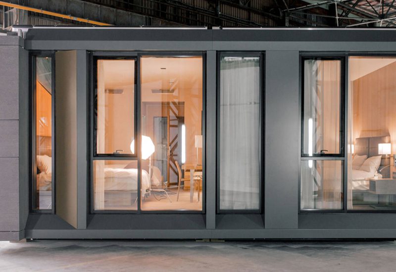 A container house is sitting in a warehouse.
