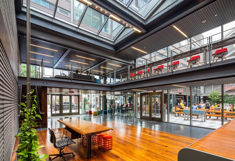 An office with a glass ceiling and wooden floors.