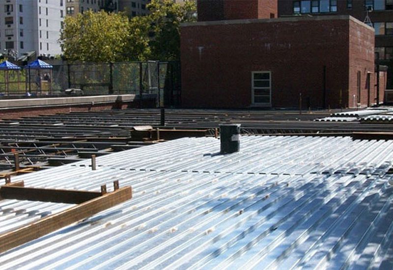 A metal roof is being constructed on a building.