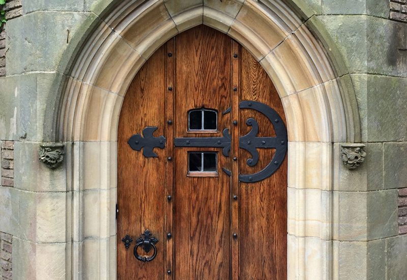 A wooden door with a cross on it.