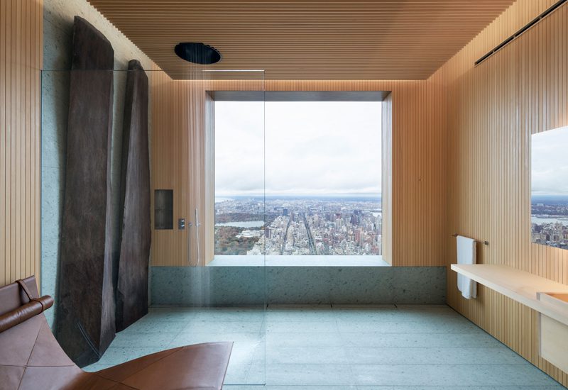 A bathroom with a view of the city.