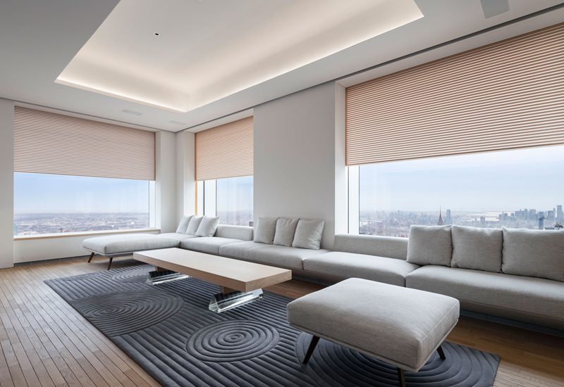 A living room with large windows overlooking the city.