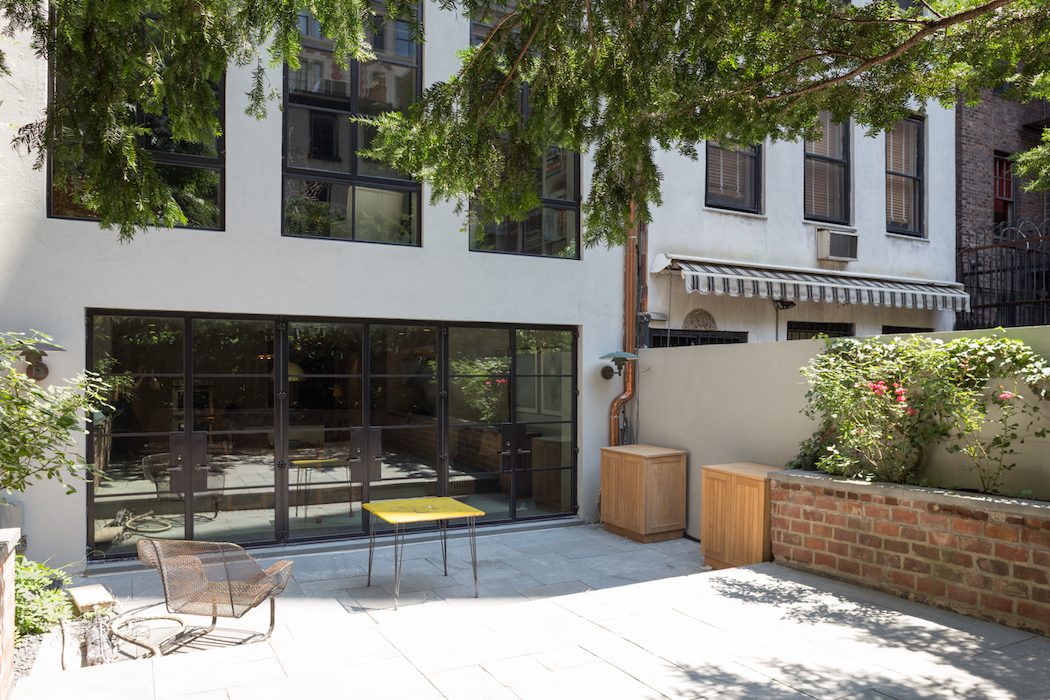 A small backyard with a table and chairs.