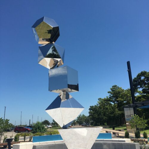 A metal sculpture with a blue sky in the background.