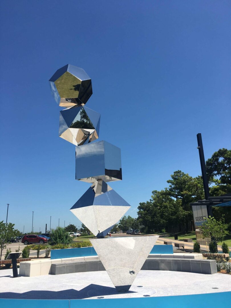 A metal sculpture with a blue sky in the background.