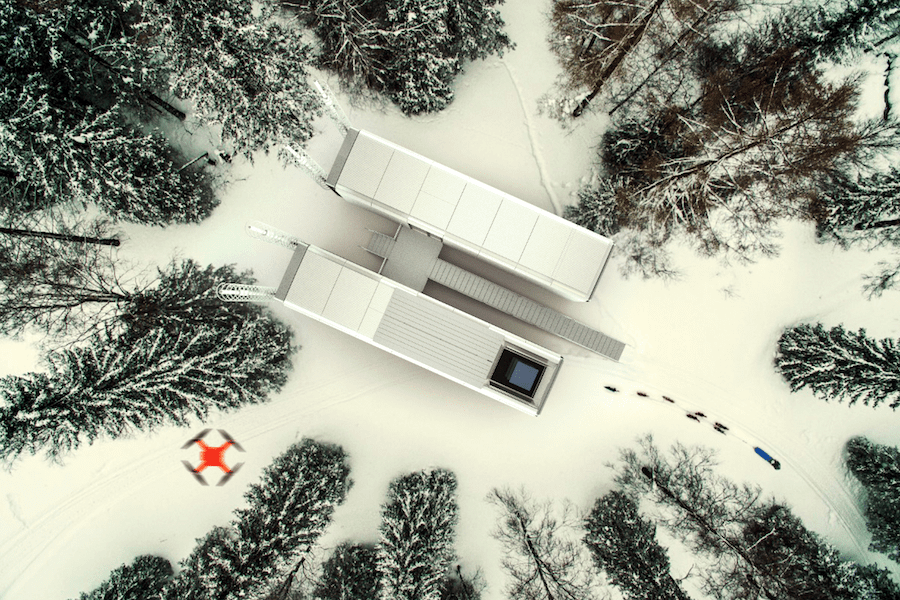 An aerial view of a white building in the snow.