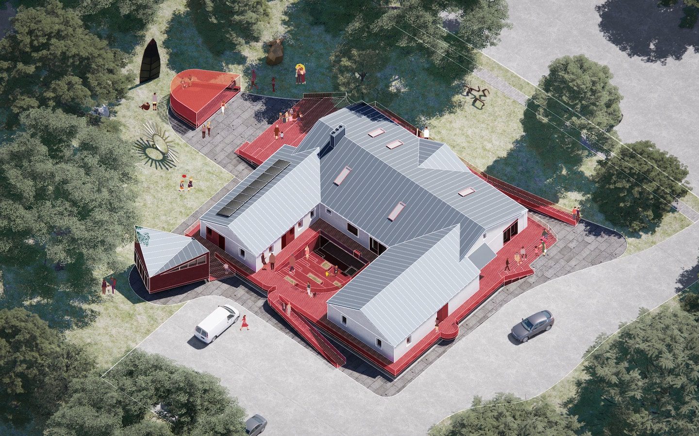 An aerial view of a red house in the woods.