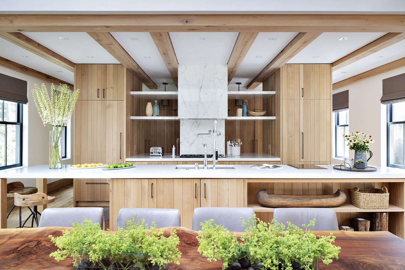 A modern kitchen with wooden cabinets and a wooden table.