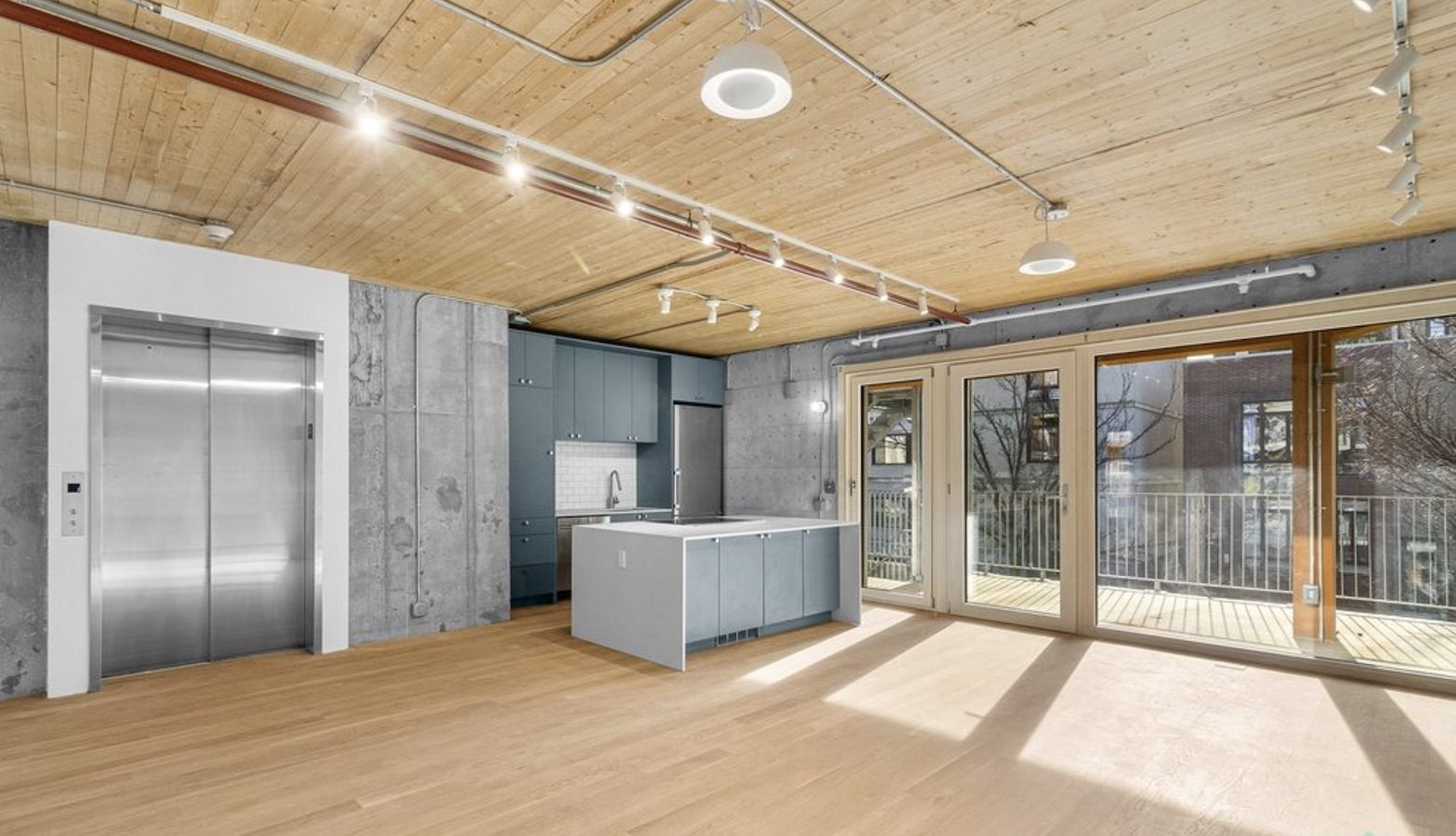 A modern apartment featuring wood floors in the first Cross Laminated Timber building in New York City.