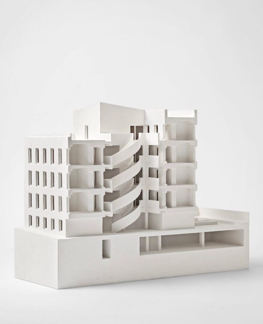 A model of a white building on a white surface.