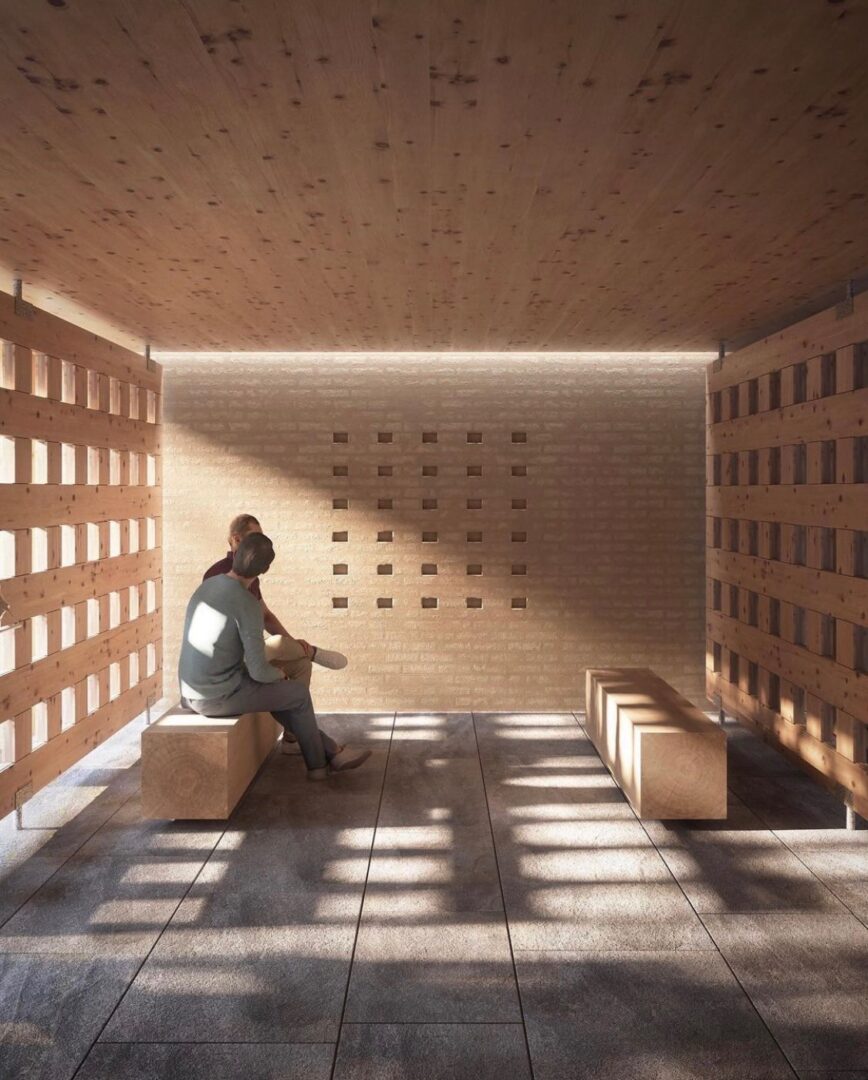 A person sitting on a bench in a wooden room.
